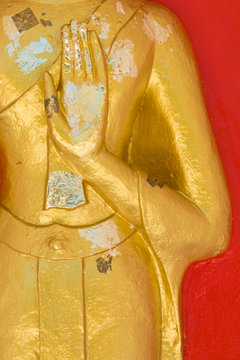 Hand of Buddha Statue on red background