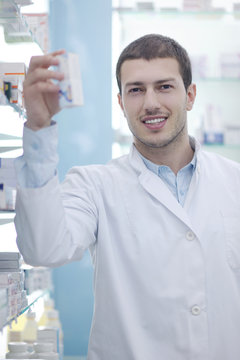 pharmacist chemist man in pharmacy drugstore
