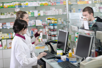 pharmacist suggesting medical drug in pharmacy drugstore