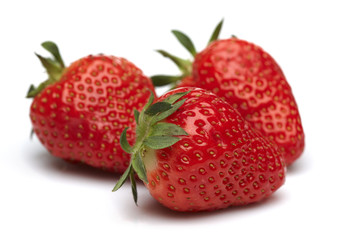 Three fresh strawberries isolated on white