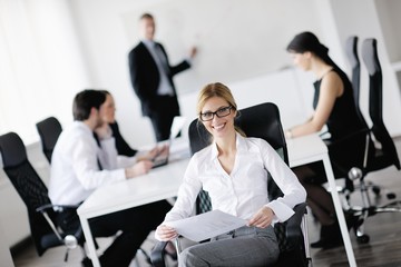 business woman with her staff in background