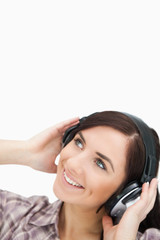 Fototapeta premium Woman enjoying music with headphones while looking up