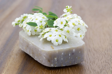 Fototapeta na wymiar bar of natural soap and white flowers