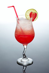 glass of red cocktail with strawberry decor
