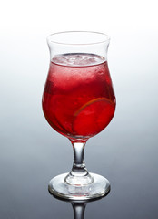glass of fresh red cocktail with lime and ice