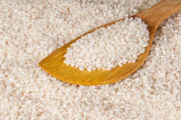 Rice in a discolored wooden spoon