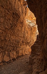 Narrow slot between two rocks in desert canyon