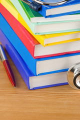 medical stethoscope with pile of book