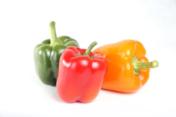 Three color red yellow green peppers in white background