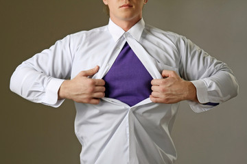 Young attractive man pulling a his t-shirt open