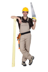 Tradesman holding a saw and a plank of wood