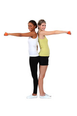 two women doing exercises with dumbbells