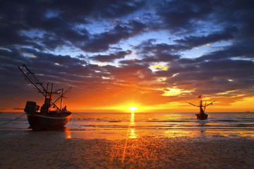 Sunset over the ocean and fishing boat