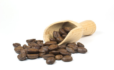 Fresh coffee beans and scoop on a white background