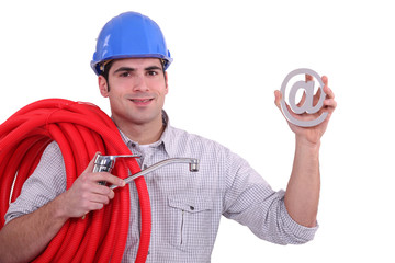 Man holding tap cable and at symbol