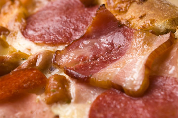 Italian pizza with bacon, salami and mozzarella cheese