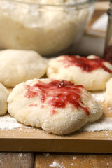 Dough with marmelade on wooden board