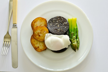 saute potatoes with black pudding, poached egg and asparagus