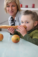 Fototapeta premium Little girl eating bread