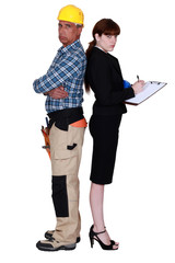 Grumpy builder stood with female supervisor