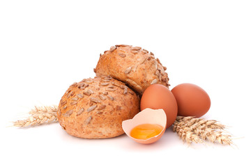 Bun with seeds and broken egg