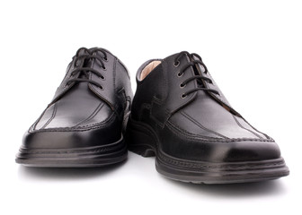 Black glossy man’s shoes with shoelaces