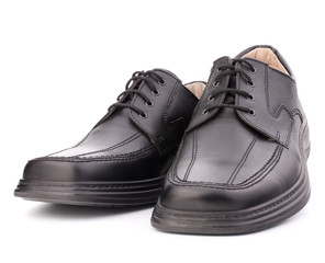 Black glossy man’s shoes with shoelaces