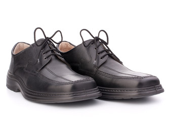 Black glossy man’s shoes with shoelaces