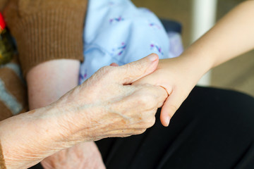 Grandmother holds the hand of his grandson