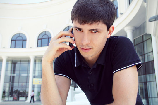 Handsome young man  using a mobile phone with copyspace