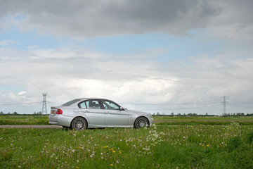Fototapeta na wymiar Car parked along a countryside road