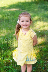 Portrait of smiling little girl in dress outdoor