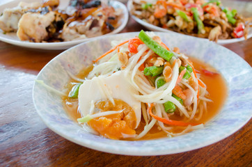 Papaya salad on table