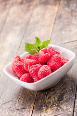 Raspberries on wooden table
