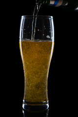 pouring beer isolated on black