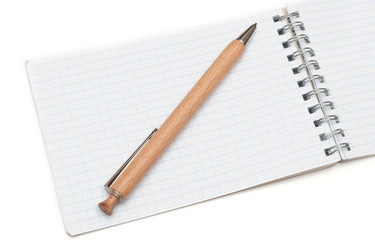 wooden ball pen and a notebook on a white background