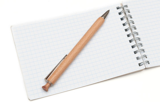 wooden ball pen and a notebook on a white background