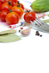 Tomatos and cucumbers on white background