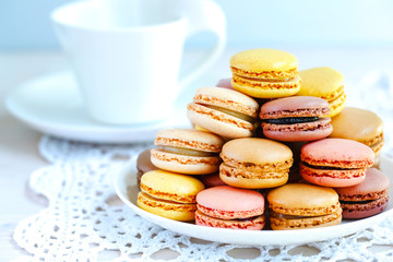 Tray full of colorful macaroons on a lace knit napkin