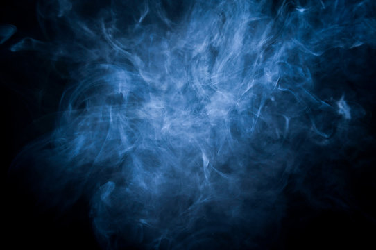 blue cloud of cigarette smoke on black background