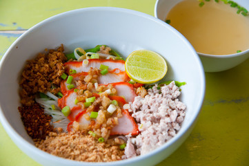 Egg chinese dry noodles with roast red pork, lemon and soup