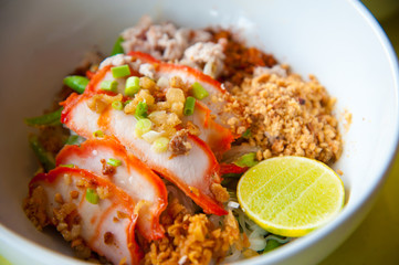 Egg chinese dry noodles with roast red pork, lemon and soup