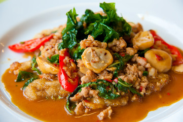 delicious fried pork, onion, chili, vegetables and green herbs