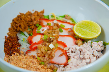 Egg chinese dry noodles with roast red pork, lemon and soup