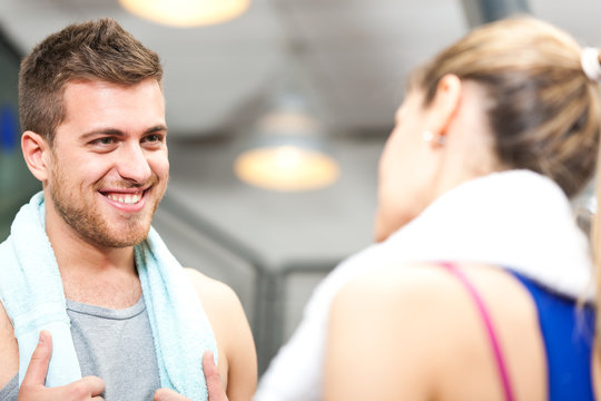 Personal Trainer Talking With A Woman In The Gym