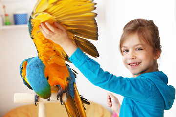 Child with ara parrot © Alena Ozerova