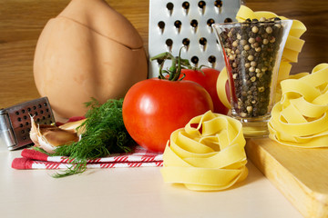 Ingredients for cooking pasta with tomatoes and herbs