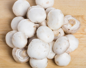 Fototapeta na wymiar Group of button mushrooms on cutting board