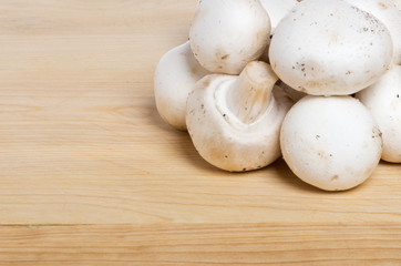 White button mushrroms on cutting board
