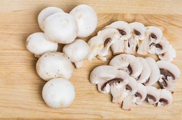 Seven white button mushrooms and slices